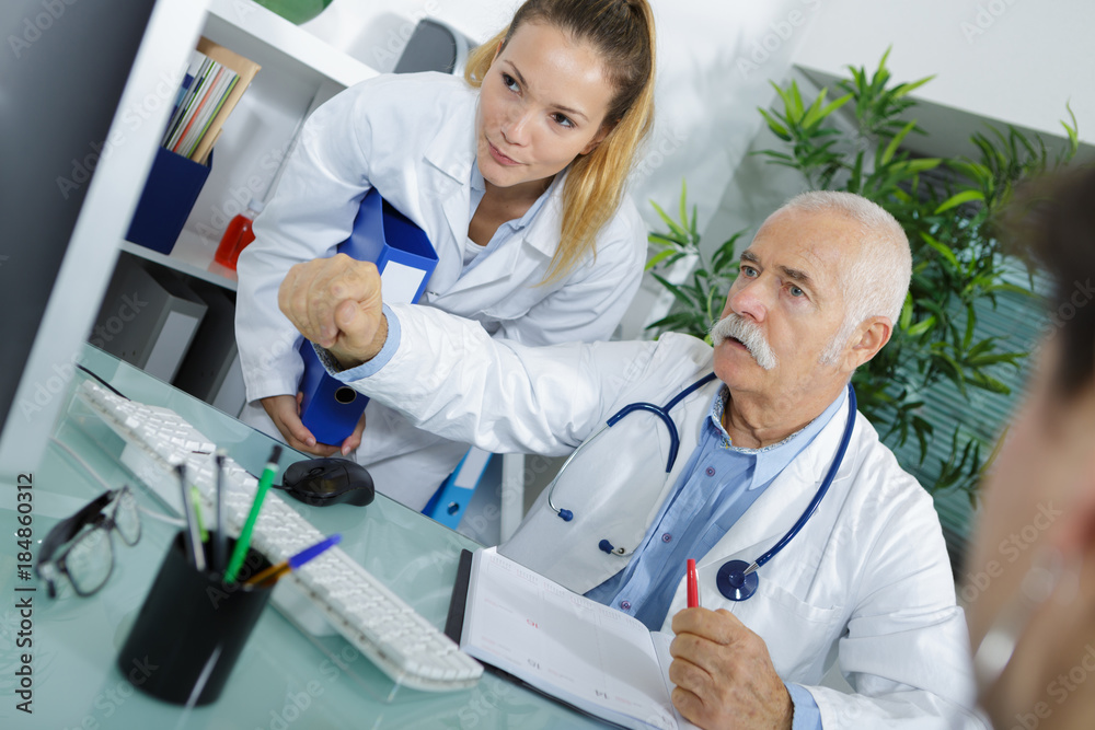 male doctor with nurse and patient showing screen male doctor with nurse and patient showing screen