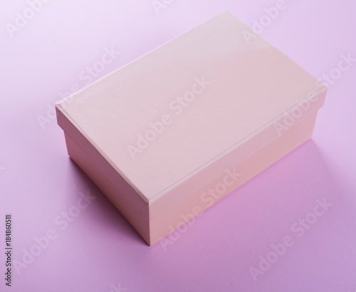 Black shoe box on pink background.