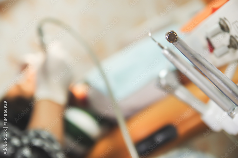 Close up of selective focus of set of metal Dentist's medical equipment tools in a blurred background Close up of selective focus of set of metal Dentist's medical equipment tools in a blurred background