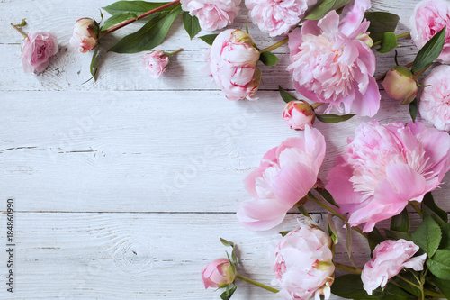 Fototapeta Naklejka Na Ścianę i Meble -  Pink peonies and roses on a wooden background