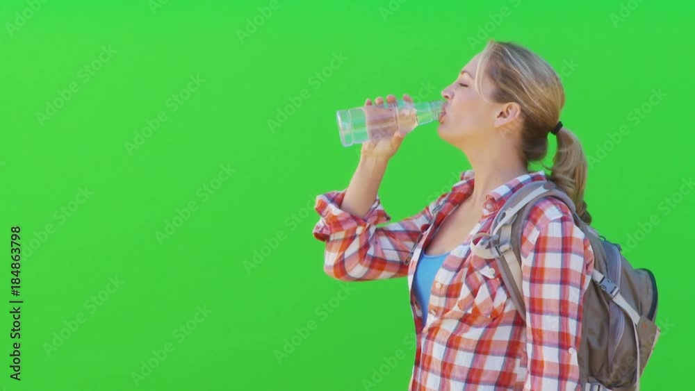 Profile of female hiker drinking from bottle of water Profile of female hiker drinking from bottle of water