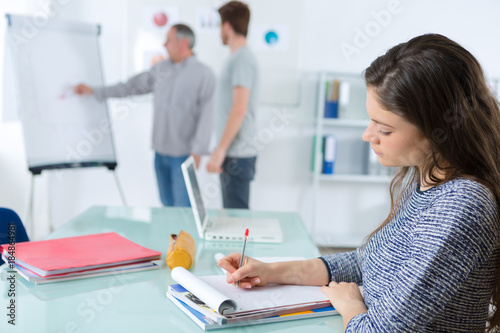 female student writing notes in the pad