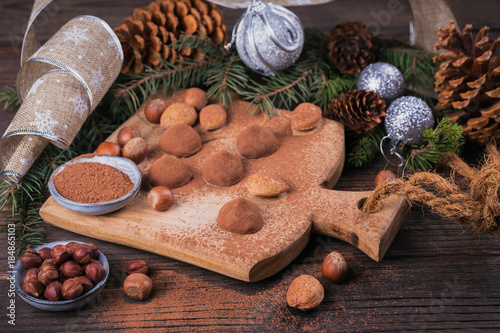 Fototapeta Naklejka Na Ścianę i Meble -  Homemade chocolate truffles, nuts, almonds and cocoa powder