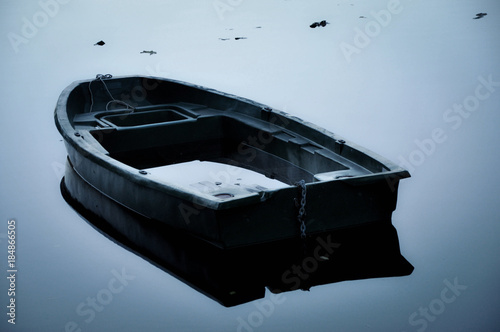 Fotografie Boat about to Sink in the Middle of a Lake