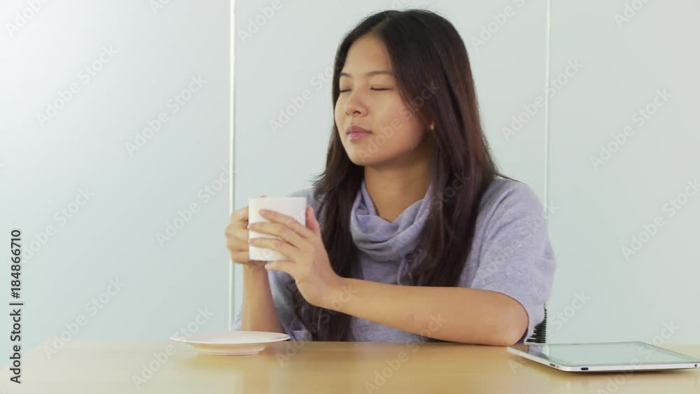 Young woman at desk with coffee Young woman at desk with coffee