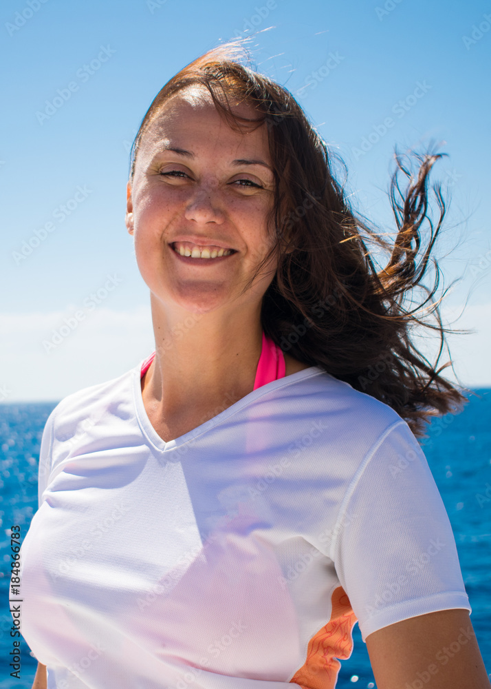 portrait of a smiling young girl with freckles on a background of azure sea. close-up portrait of a Slavic girl. portrait of a smiling young girl with freckles on a background of azure sea. close-up portrait of a Slavic girl.