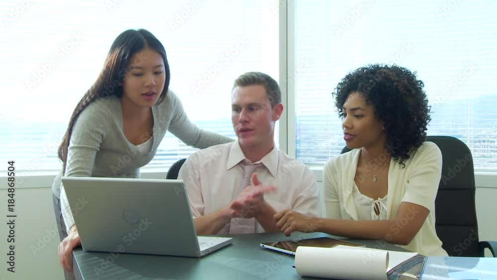 Young business colleagues discussing work at desk area Young business colleagues discussing work at desk area
