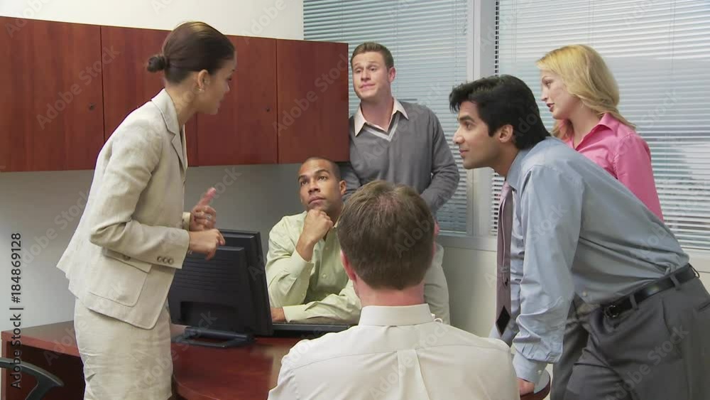 Group of businesspeople talking in crowded office Group of businesspeople talking in crowded office