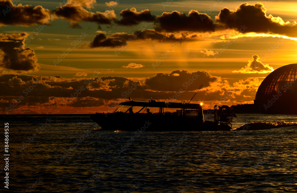 silhouette of the boats floating away into the sunset