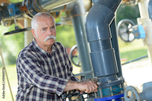 mature man standing on waste water treatment unit