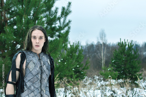 Obraz na plátně man in the suit an elf in the winter forest