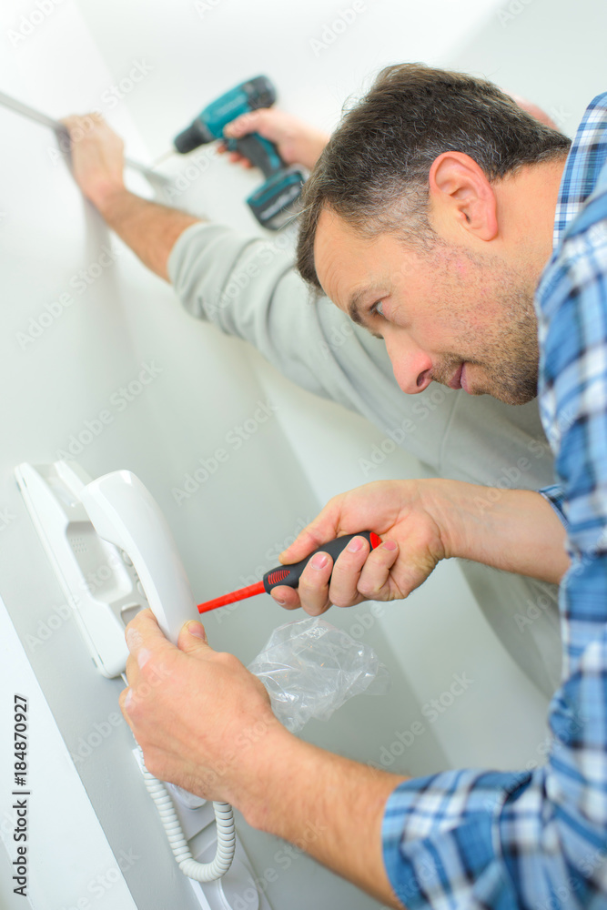 skilled entrepreneur installing new intercom system skilled entrepreneur installing new intercom system
