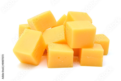 Cubes of cheddar cheese isolated on white photo