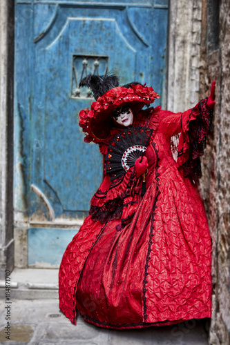 Venice carnival 2017. Venetian Carnival Costume. Venetian Carnival Mask. Venice, Italy. Venetian red carnival costume.