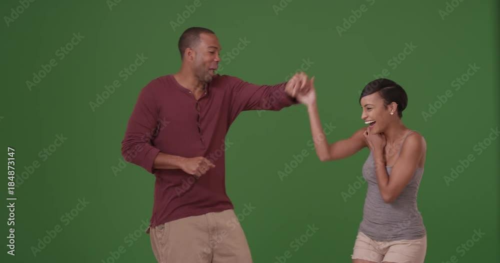An African American couple dance on green screen. On green screen to be keyed or composited. An African American couple dance on green screen. On green screen to be keyed or composited.