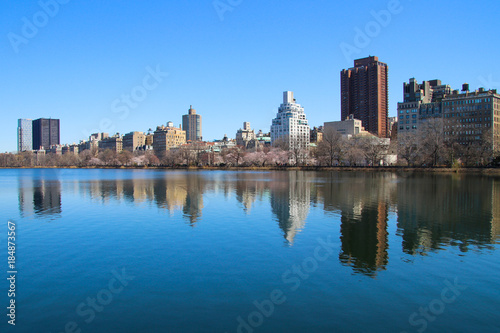 The cityscape with reflection in the water  blue lake and blue sky