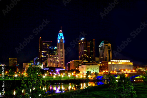 Columbus,Ohio skyline sparkles along the Scioto River with the Broad St. Bridge.