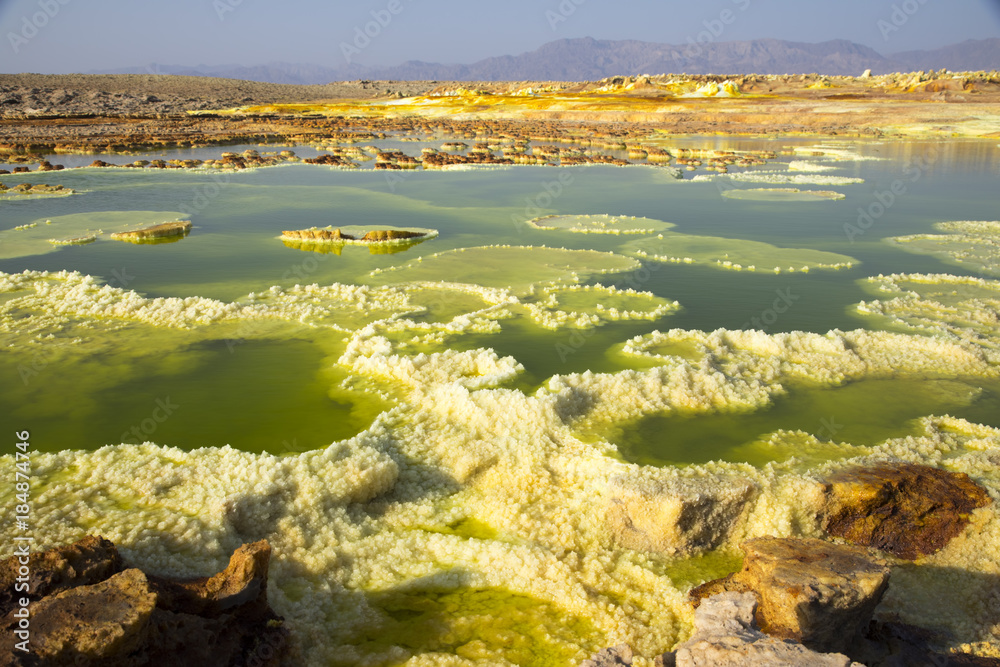 Dalol, Dankakil Depression.  Volcanic hot springs of Ethiopia. Earth’s lowest land volcano.  The craters contains hot springs that boast a whole range of otherworldly colours, including neon yellow.