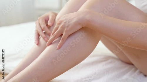 girl touching long leg smoothly up. photo