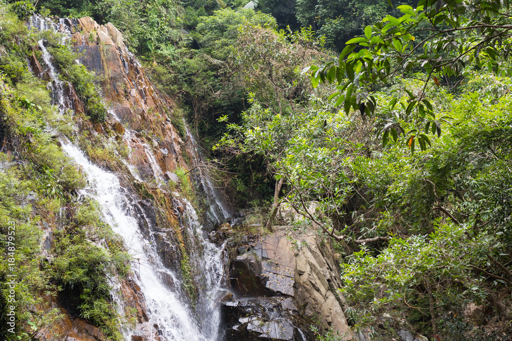Big waterfall in a tropical forest national park Ya Nuo Da in China on island of Hainan