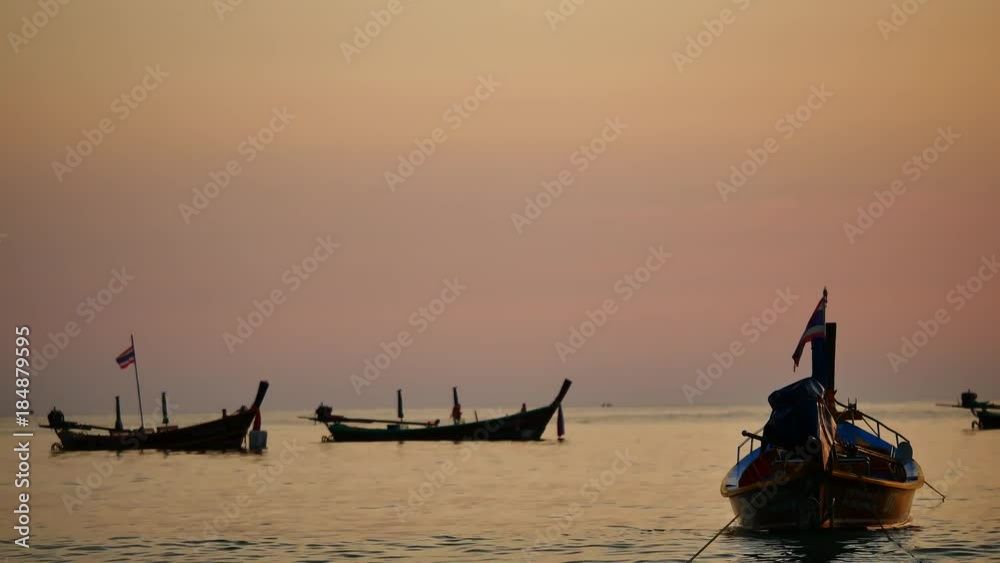 Travel video Group of silhouette long tail boat converted to boat excursions floating in the andaman sea with golden light of the Sun before sunset in travel or transportation concept. Travel video Group of silhouette long tail boat converted to boat excursions floating in the andaman sea with golden light of the Sun before sunset in travel or transportation concept.