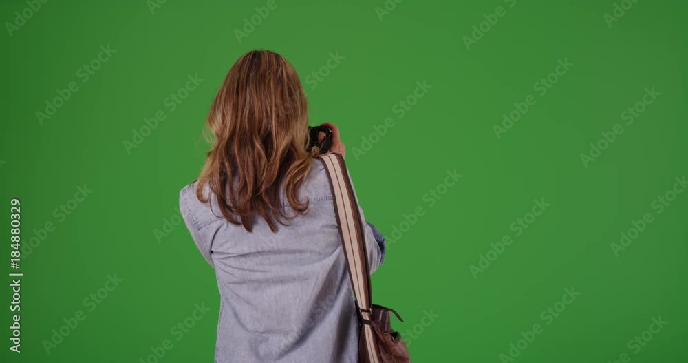 Woman taking photo on green screen. On green screen to be keyed or composited. Woman taking photo on green screen. On green screen to be keyed or composited.