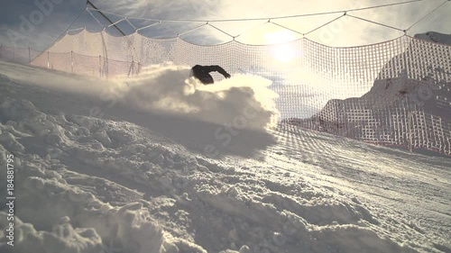 Person Goes Down On Skis To A Snowbord On A Hillside. Gorki Gorod photo