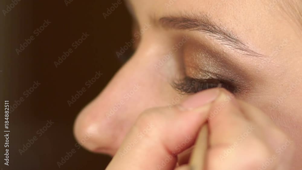Make-up artist doing make-up for beautiful girl in the salon, beauty concept and style. Close-up. Make-up artist doing make-up for beautiful girl in the salon, beauty concept and style. Close-up.