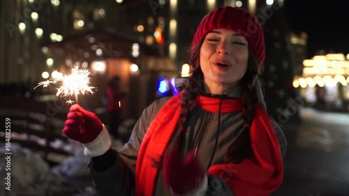 The Young Beautiful Woman Holds A Bengal Light And Smiles photo