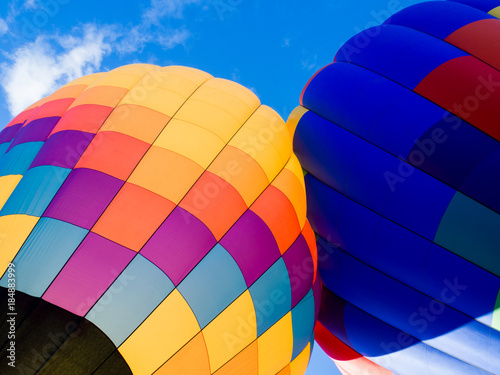 Two colorful hot air balloons on the ground ready to take off - at Winthrop Balloon Festival, Washington state