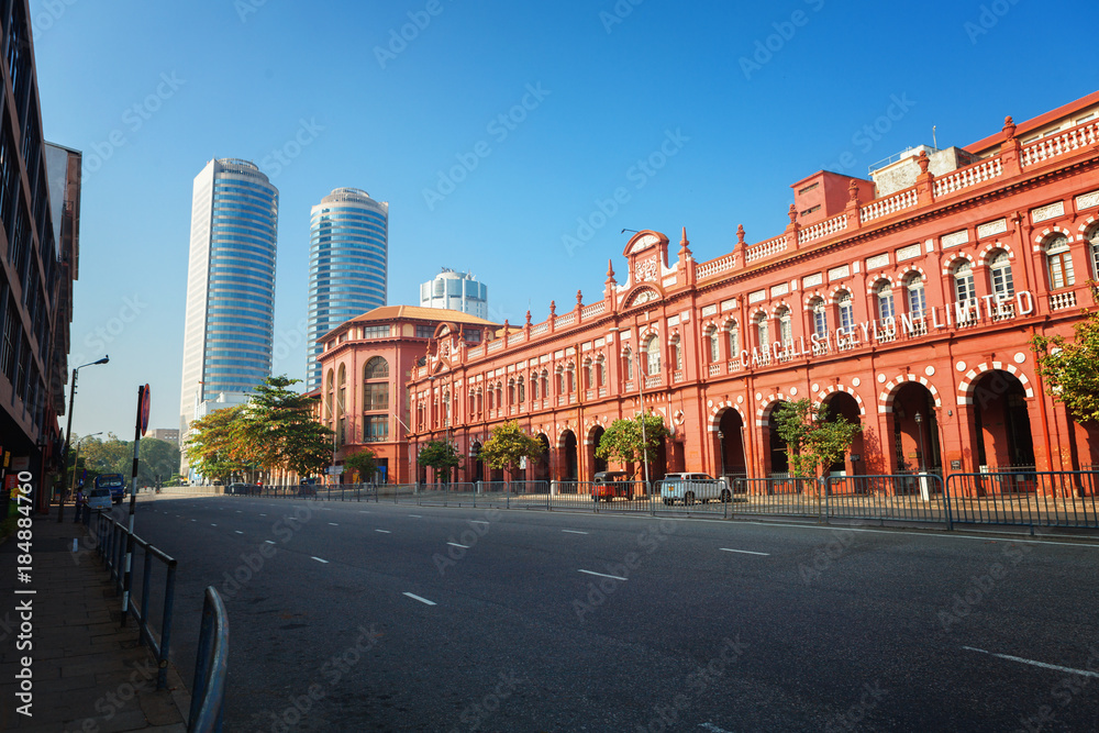 Colombo, Sri Lanka - 11 February 2017: The red building of Cargills and Miller in York Street with the skyscrapers of World Trade center