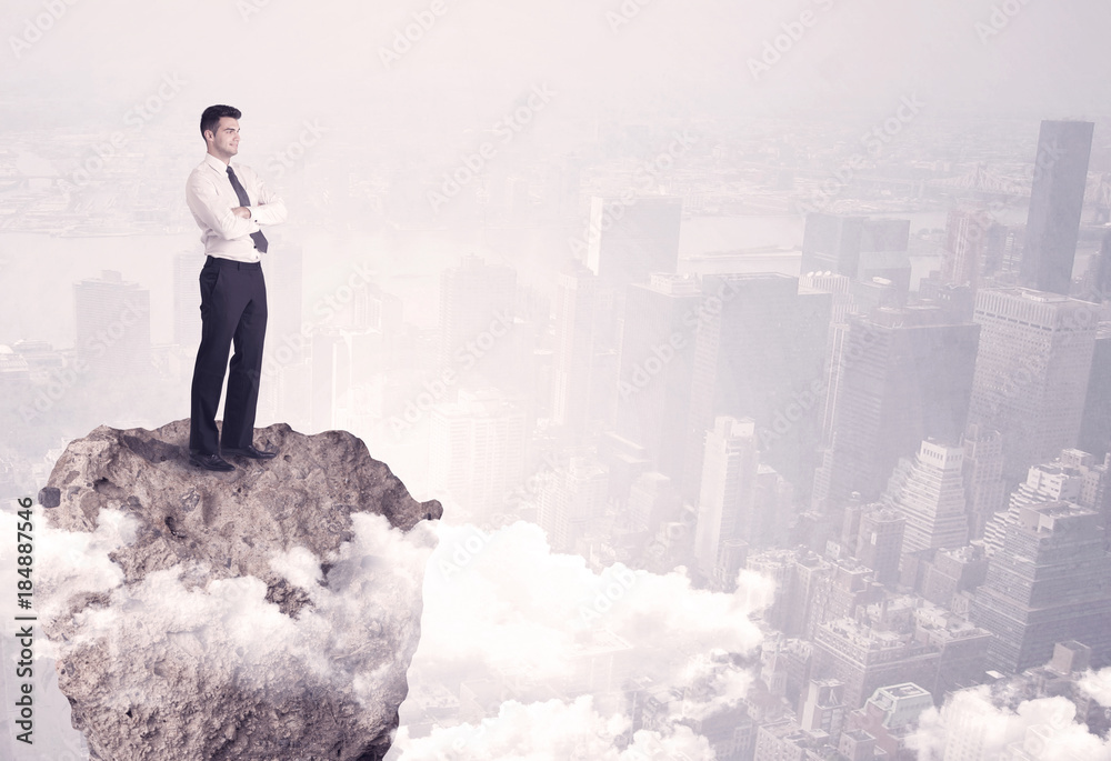 Winner business person standing on rock Winner business person standing on rock