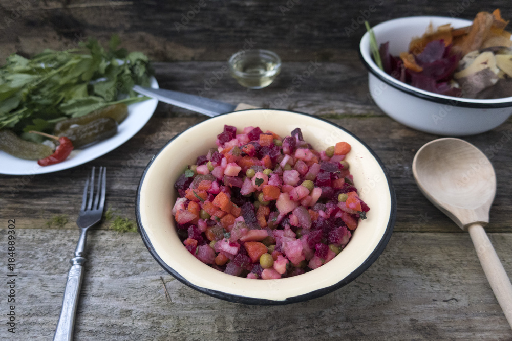 Vinaigrette is located on a wooden table, as well as pickled cucumbers and greens and cleaning leftover from the preparation of vinaigrette. Vinaigrette is located on a wooden table, as well as pickled cucumbers and greens and cleaning leftover from the preparation of vinaigrette.