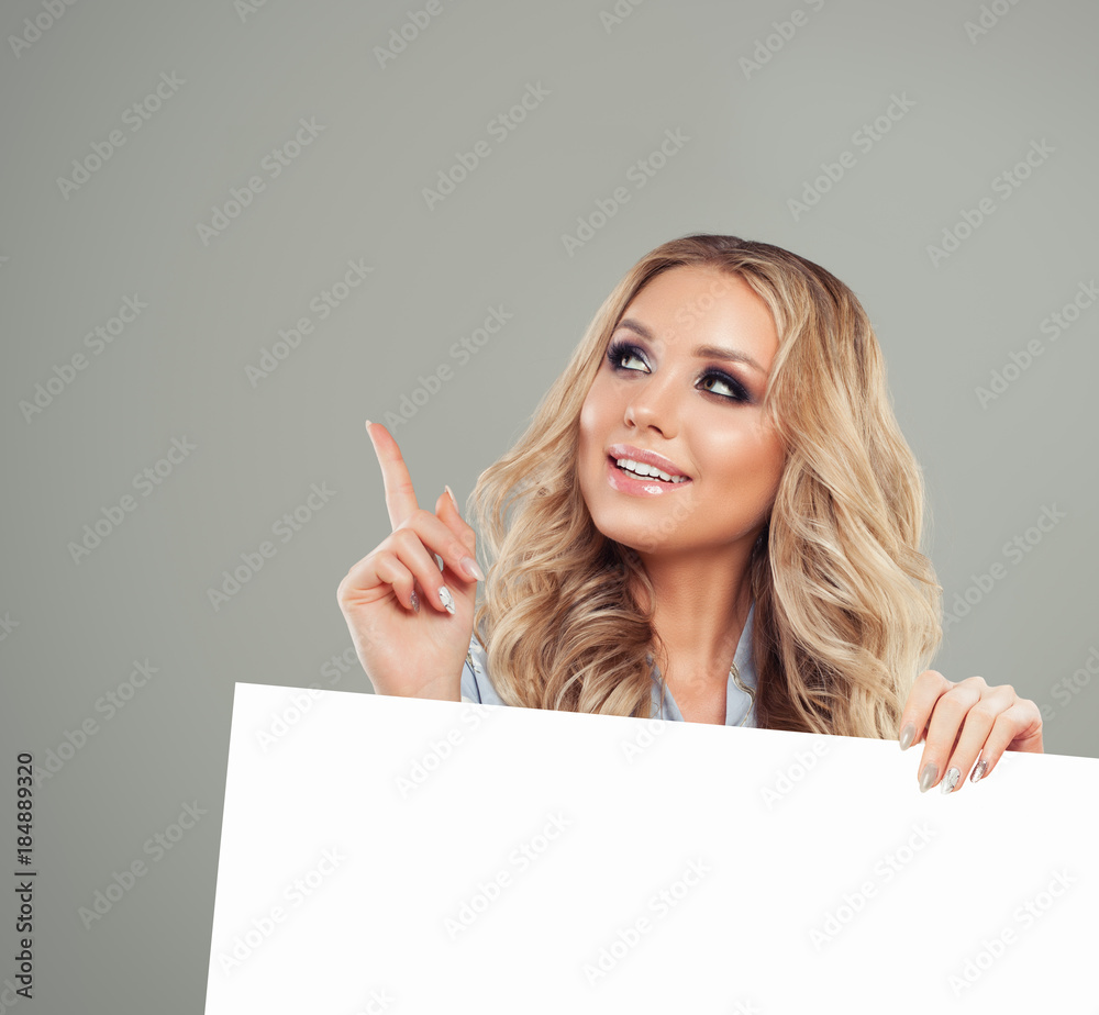 Naklejka premium Smiling Woman Pointing her Finger and Holding White Paper Banner Background