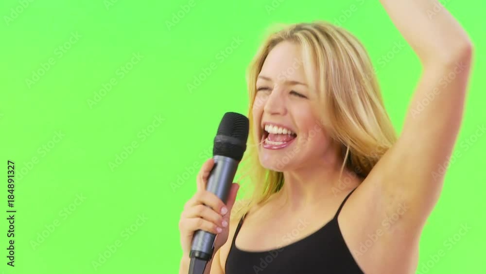 Woman singing karaoke with microphone Woman singing karaoke with microphone