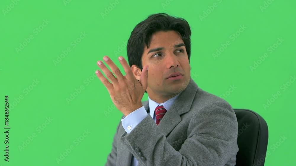 East Indian businessman thinking on greenscreen