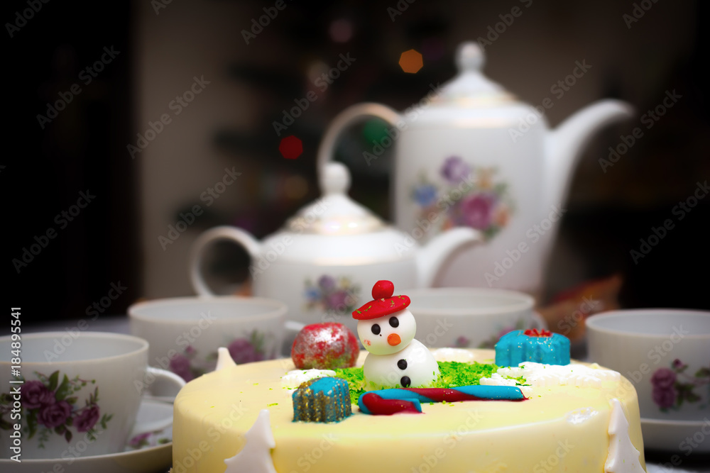 Homemade Christmas creamy cake, decorated with a Christmas character