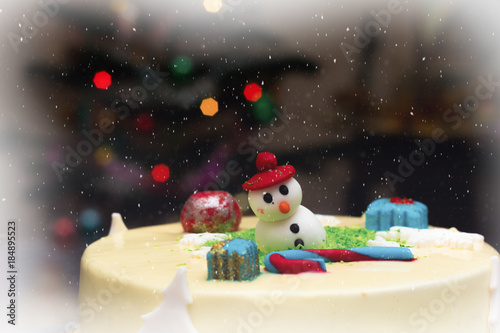 Homemade Christmas creamy cake, decorated with a Christmas character