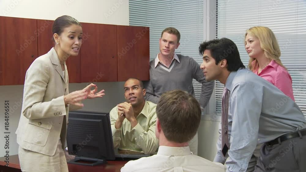 Group of businesspeople talking in crowded office Group of businesspeople talking in crowded office