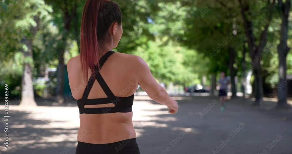 Sporty Asian-American female warms up for run at the park Sporty Asian-American female warms up for run at the park