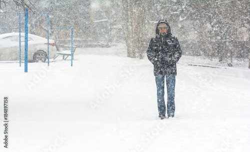 A person walks through deep snow