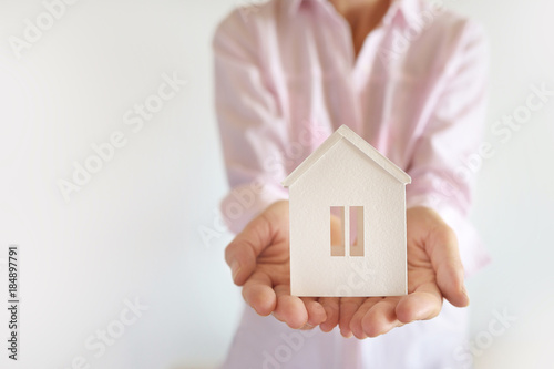 Female hands hold the model of the White House