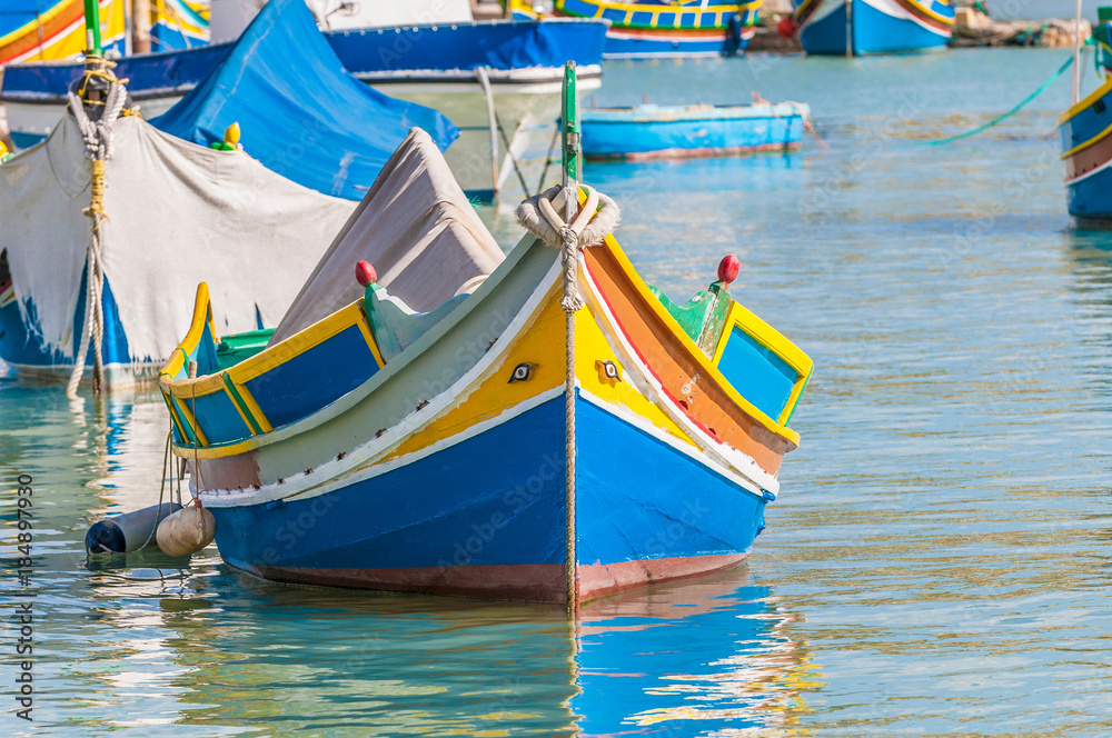 Traditional Luzzu boat at Marsaxlokk harbor in Malta. Traditional Luzzu boat at Marsaxlokk harbor in Malta.