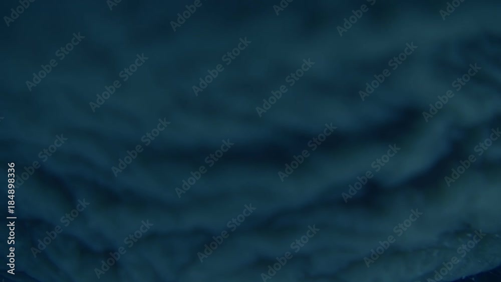 A blinking eye with a mechanical diaphragm instead of a pupil and red light from the inside, like the terminator. Macro. Closeup
