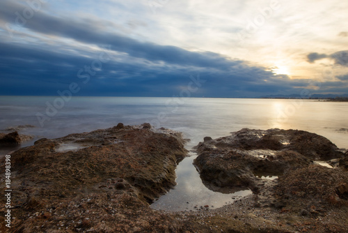 The calm sea in a very cloudy sunset © vicenfoto