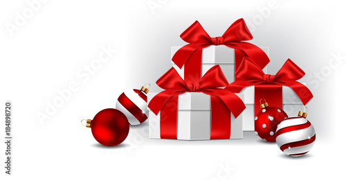 Gift boxes with red bows isolated and balls on white background photo