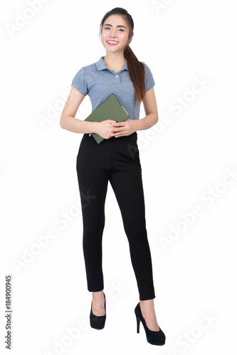 Smiling young woman in gray polo shirt is holding notebook in hand on a white background