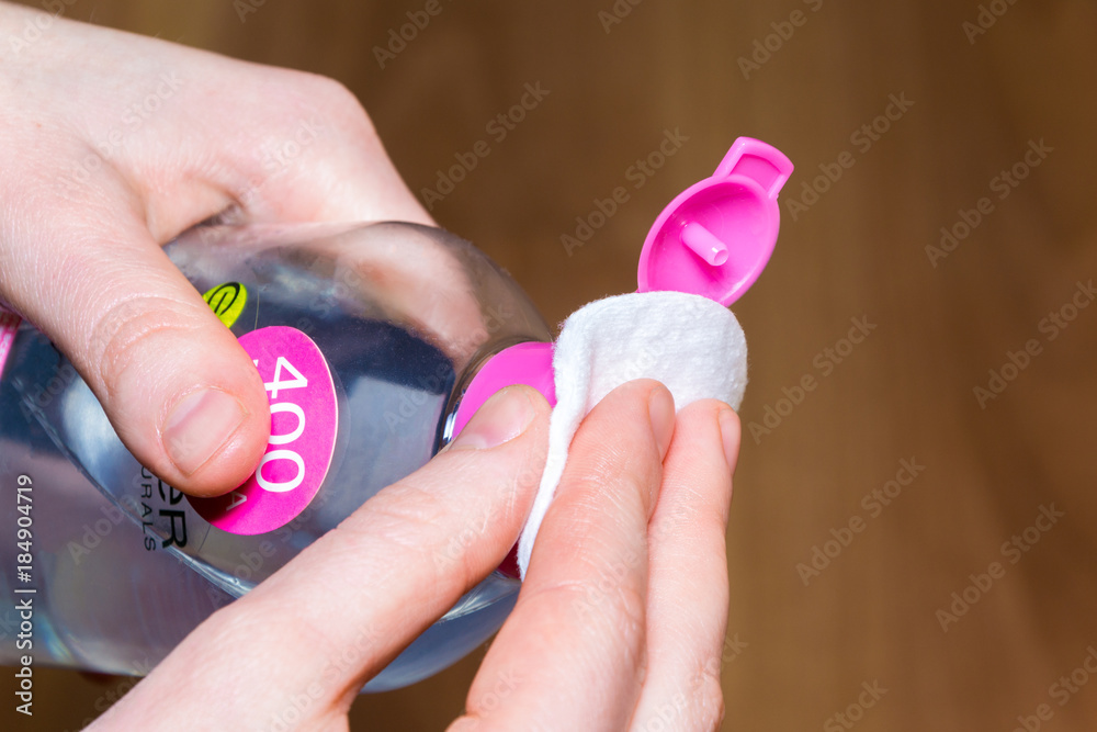 Morning routine. Young woman using cosmetics on hands Morning routine. Young woman using cosmetics on hands
