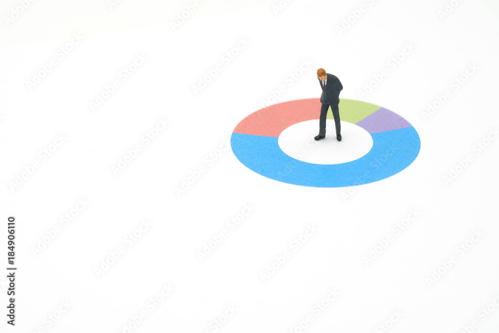 Miniature people businessmen analyze standing on Circle graph with performance as background strategy concept and Business concept with copy space.