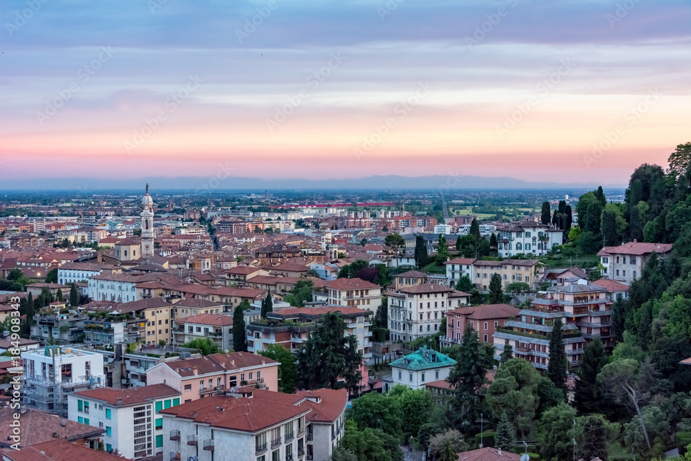 The city of Bergamo's red sky over many small houses